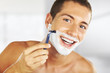 young man shaving in the bath