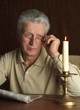 Beautiful Caucasian elderly man sitting at a table