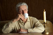 Beautiful Caucasian senior man sitting at a table