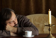 Beautiful Caucasian elderly male sitting at a table