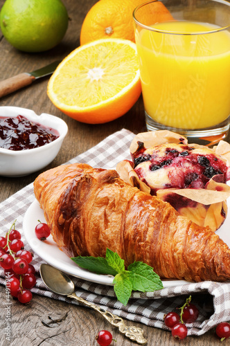 Photo: Breakfast with orange juice, fresh croissant and cake Breakfast with orange juice, fresh croissant and cake