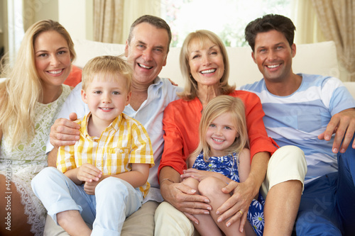 Photo: Multi Generation Family Relaxing On Sofa At Home Multi Generation Family Relaxing On Sofa At Home
