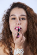Woman applying lipstick