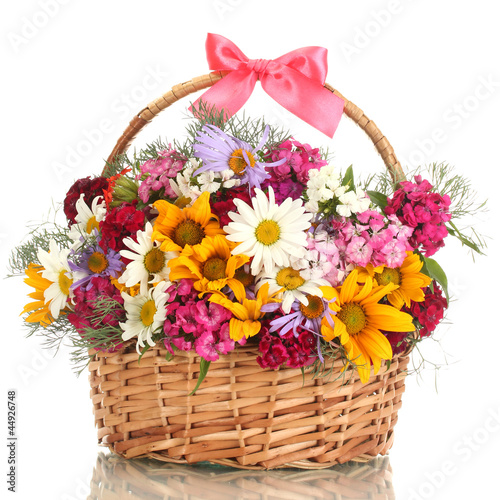 Photo: beautiful bouquet of bright wildflowers in basket, isolated beautiful bouquet of bright wildflowers in basket, isolated