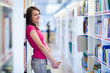 Photo: Pretty young college student in a library Pretty young college student in a library