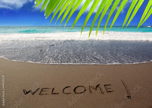 Photo: Brown sand beach with written word Welcome Brown sand beach with written word Welcome