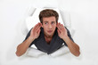 Young man straining his ears