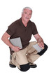 Middle-aged man fitting tiles