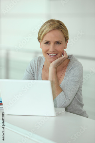 Photo: Blond woman in front of laptop computer Blond woman in front of laptop computer
