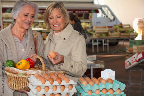 Photo: two senior women shopping on the market two senior women shopping on the market