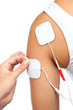 electrodes of tens device on shoulder, tens therapy, nerve stimu