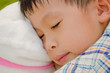 asain boy sleeping in the garden