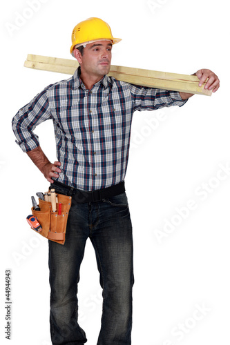 Photo: craftsman carrying a wooden board craftsman carrying a wooden board