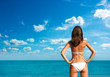 Photo: Woman in White Bikini at the Sea. Rear View. Woman in White Bikini at the Sea. Rear View.