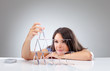 Young woman is making a house of cards 1
