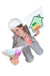 Tradeswoman holding up cash and an energy chart