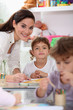 Young teacher and children in a classroom