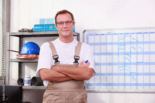 Photo: Man in store with arms crossed Man in store with arms crossed