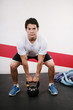 Young man Lifting Crossfit Kettle Bell