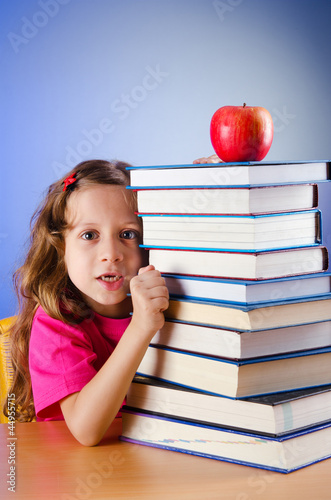 Photo: Little girl with books on white Little girl with books on white