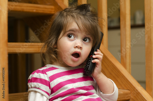 Photo: Little girl speak on the phone Little girl speak on the phone