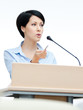 Female presenter at the podium. Business conference