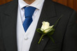 groom wearing rose buttonhole