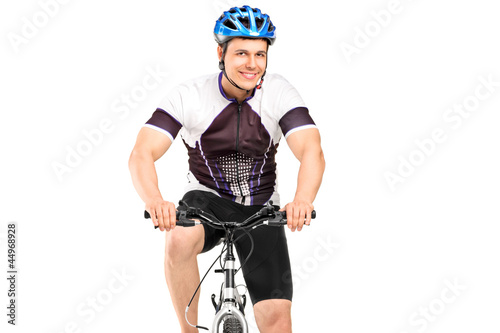 Photo: A male bicyclist posing on a bicycle A male bicyclist posing on a bicycle