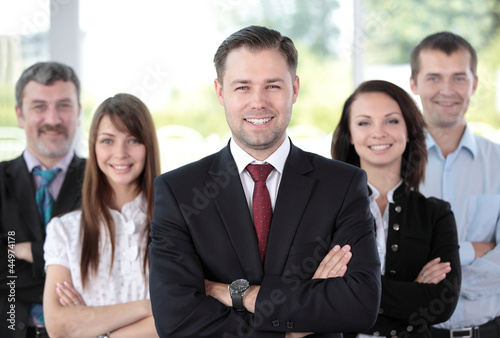 Photo: professional business team looking confidently at camera professional business team looking confidently at camera