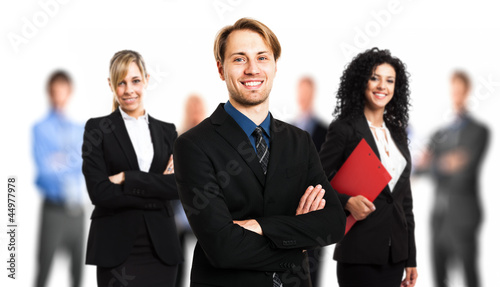 Photo: Businessman in front of his team Businessman in front of his team