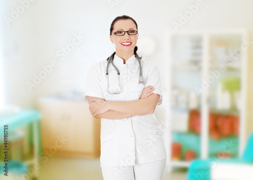 Photo: Beautiful woman in medical uniform and stethoscope. Beautiful woman in medical uniform and stethoscope.