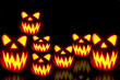 Spooky group of Halloween jack-o-lanterns at night