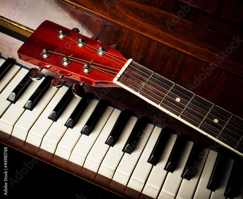 Photo: guitar neck on old piano keys guitar neck on old piano keys