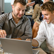 Men business partners working on laptop cafe