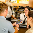 Man paying with credit card at cafe