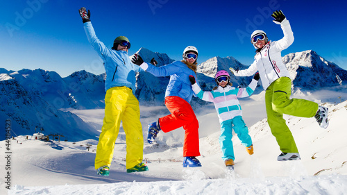 Photo: Ski, snow, sun and winter fun - happy family ski team Ski, snow, sun and winter fun - happy family ski team