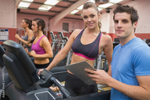 Photo: Gym Instructor and woman in the gym Gym Instructor and woman in the gym
