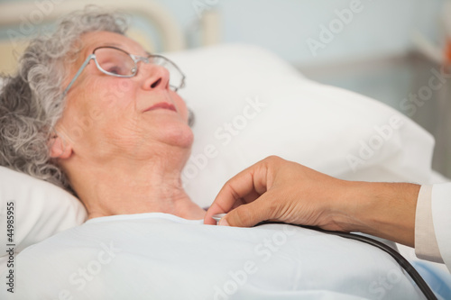 Photo: Doctor using stethoscope on elderly patient Doctor using stethoscope on elderly patient