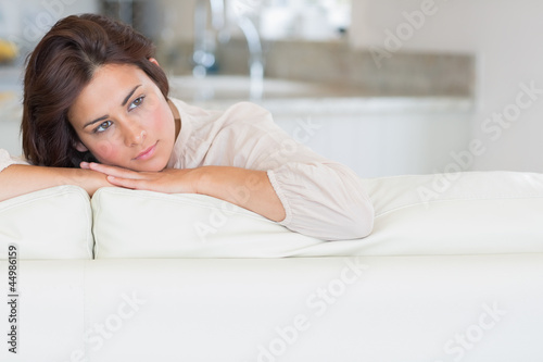 Photo: Thoughtful woman relaxing on the couch Thoughtful woman relaxing on the couch