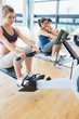 Man and women using the row machines