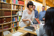 Woman taking out book