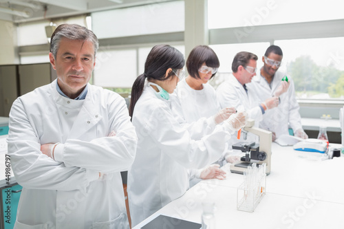 Photo: Chemist in busy lab Chemist in busy lab