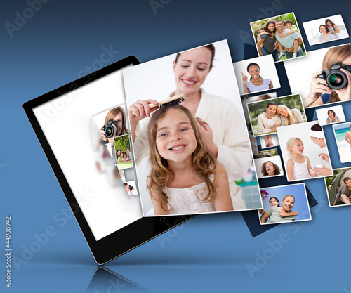 Photo: Tablet computer showing many family images Tablet computer showing many family images