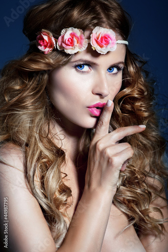 Photo: Beautiful woman with long , shiny hair and flowers on nead. Beautiful woman with long , shiny hair and flowers on nead.