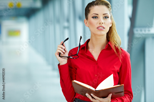 Photo: business woman in modern glass interior business woman in modern glass interior