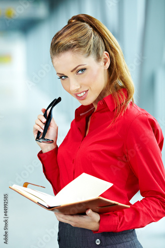 Photo: business woman in modern glass interior business woman in modern glass interior