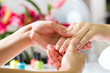 Woman in nail salon receiving hand massage