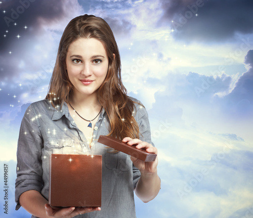 Photo: Beautiful Woman Opening a Gift Box Beautiful Woman Opening a Gift Box