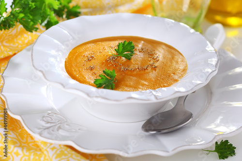 Photo: Pumpkin soup in white bowl, soft focus. Pumpkin soup in white bowl, soft focus.