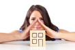 Young woman illustrates a roof with hands